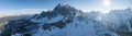Panoramic view of snow covered kronplatz mountains against shining sun in sky Royalty Free Stock Photo
