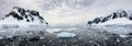 Panoramic view of snow covered mountains and water with ice, Lemaire Channel, Antarctica Royalty Free Stock Photo