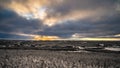 A panoramic view of the snow covered trees in the snowdrifts horizon. Natural landscape with dramatic beautiful sunrays through Royalty Free Stock Photo