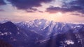 Panoramic view of snowy mountains and rays of the sun