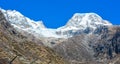 Panoramic view of a snowy mountainside. The glow of the sun illuminates the fall colors, along with the first snow found high up i Royalty Free Stock Photo