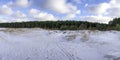 Panoramic view of snowy sea coast with covered in snow dunes and pine forest during sunny day in winter. Covered in snow Baltic Royalty Free Stock Photo