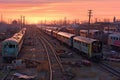 panoramic view of a sprawling train graveyard at dusk
