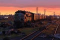 panoramic view of a sprawling train graveyard at dusk