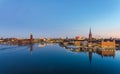 Panoramic view of Stockholm city at dawn, reflected over frozen water. Royalty Free Stock Photo