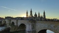 Panoramic view of the stone bridge and the Basilica del Pilar at sunset in Zaragoza, Spain Royalty Free Stock Photo