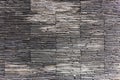 Panorama of a stone wall wetted by rain, dark, solemn colors, decoration, decoration, stone material