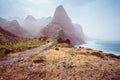 Panoramic view of stony hiking path to Ponta do Sol over amazing arid Aranhas valley with huge mountain peak and house