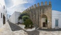 Panoramic view of a street in Vejer de la Frontera and one of the gates of
