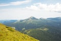 Panoramic view of the summer Carpathian Mountains from Petros Mount. Green hills with pine-trees. Active rest in mountains