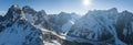 Panoramic view of sun shining over snow covered mountain range during winter Royalty Free Stock Photo