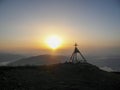 A panoramic view on a sunrise with small tower with a cross on the top on the peak of Gerlitzen, Austrian Alps. Royalty Free Stock Photo