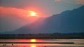 Panoramic view of sunset on the african Zambezi river. The dramatic, red sky reflects on the surface of the border river. View Royalty Free Stock Photo