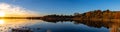 Panoramic view of sunset with fall colors with reflections in the lake Royalty Free Stock Photo