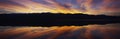 Panoramic view at sunset of flooded salt flats and Panamint Range Mountains in Death Valley National Park, California Royalty Free Stock Photo