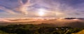 Panoramic view of a sunset over a sea of clouds covering south San Francisco bay area; beautiful rolling hills in the foreground;