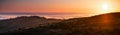 Panoramic view at sunset of valley covered in a sea of clouds in the Santa Cruz mountains, San Francisco bay area, California Royalty Free Stock Photo