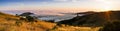 Panoramic view at sunset of valley covered in a sea of clouds in the Santa Cruz mountains, San Francisco bay area, California Royalty Free Stock Photo