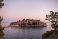 Panoramic view of Sveti Stefan in Montenegro at pink sunset. Famous tourist place near Budva Natural Royalty Free Stock Photo