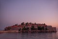 Panoramic view of Sveti Stefan in Montenegro at pink sunset. Famous tourist place near Budva Natural Royalty Free Stock Photo