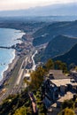 Taormina shore at Ionian sea with Giardini Naxos and Villagonia towns and Mount Etna volcano in Messina region of Sicily in Italy Royalty Free Stock Photo