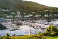 Panoramic view of Tarbert harbor and yacht marina at sunset.