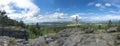 Panoramic view from Tempelwand sandstone viewpoint with wooden cross on hill Topfer, Oybin with view of Zittau and