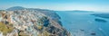 Panoramic view of Thira town with traditional and famous houses and churches with blue domes over the Caldera on Santorini island.