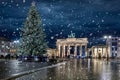 Panoramic view to the famous Brandenburg Gate in Berlin, Germany, with a Christmas tree and snow