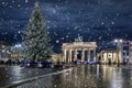 Panoramic view to the famous Brandenburg Gate in Berlin, Germany, with a illuminated christmas tree