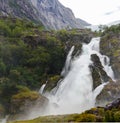 Panoramic view to kleivafossen waterfall at briksdalselva river, Briksdalsbreen glacier, Norway Royalty Free Stock Photo