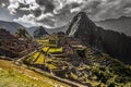 Panoramic view to old Inca ruins and Wayna Picchu with grey clou Royalty Free Stock Photo
