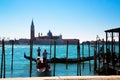 A panoramic view to the Venice lagoon, San Giorgio Maggiore island, to gondolas with tourists and gondolier moving to the San