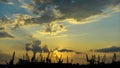 Panoramic view toward sea port and industrial cranes. sunset