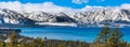 Panoramic view towards Lake Tahoe on a sunny clear day; the snow covered Sierra mountains in the background; evergreen forests in Royalty Free Stock Photo