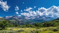 A panoramic view of towering mountains against a brilliant blue sky epitomizes summer beauty