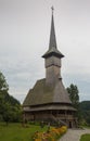 Panoramic view of traditional ancient Maramures wooden orthodox church in Transylvania with highest wooden belltower in Royalty Free Stock Photo