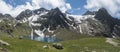 Panoramic view of turquoise blue mountain lake Grunausee in alpine landscape with green meadow and snow-capped mountain Royalty Free Stock Photo