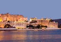 Panoramic view of the Udaipur City Palace at sunset from lake Pichola in Rajasthan, India