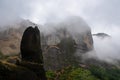 Panoramic view of unique rock formations near mountain Aghio Pnevma (Holy Spirit) on cloudy foggy day in Kalambaka, Meteora
