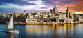 Panoramic view of Valetta over sunset and with a sail boat. Malt
