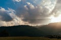 Panoramic view of a valley surrounded by hills at sunset with the sun Royalty Free Stock Photo