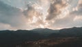 Panoramic view of a valley surrounded by hills at sunset with the sun Royalty Free Stock Photo