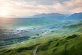 Beautiful landscape of valley with village and rural road in morning sunlight sky Royalty Free Stock Photo