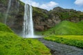 Panoramic view of valley and waterfall Seljalandsfoss in Iceland Many tourists follow the path to see the back of the waterfall Royalty Free Stock Photo