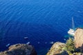 Panoramic view of vast blue mediterranean seascape copy space with light wave, sailing ships and rock mountain foreground