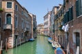 Panoramic view of Venice narrow canal with historical buildings and boat Royalty Free Stock Photo