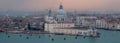 Panoramic view of Venice skyline at dusk on a clear day showing the Basilica di Santa Maria della Salute and Grand Canal