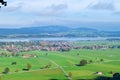 Panoramic view of a village in the Alps in Germany in the morning with green meadows Royalty Free Stock Photo