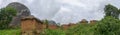 Panoramic view of a village with terracotta and straw houses, tropical landscape